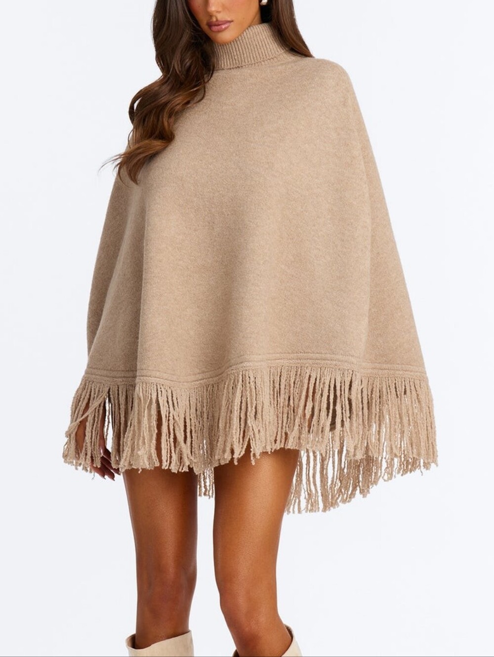 Stylish and cozy knitted poncho with fringes - the perfect choice for creating